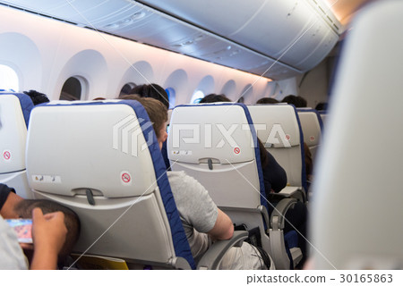man sleep in airplane during travel abroad man sleep in airplane during travel abroad 30165863