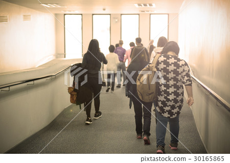 passengers walk on walk way to go to airplane. passengers walk on walk way to go to airplane. 30165865