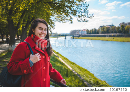 Portrait of happy smiling woman standing near the Portrait of happy smiling woman standing near the 30167350