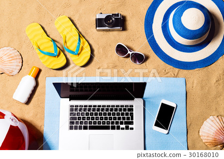 Summer vacation composition. Sandals, hat, laptop 30168010