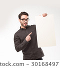 Young happy man showing presentation, pointing on 30168497