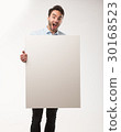 Young happy man showing presentation, pointing on 30168523