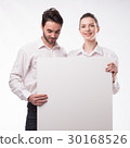Young happy couple showing presentation pointing 30168526