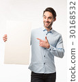 Young happy man showing presentation, pointing on 30168532