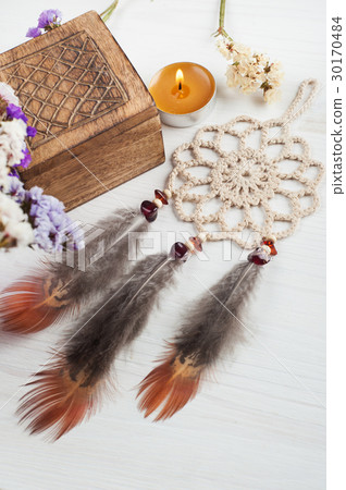 Wooden box and beige dream catcher, lit candle 30170484