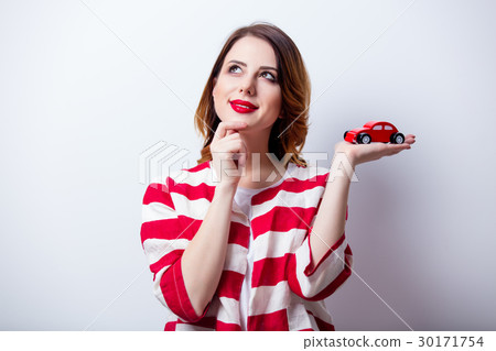 young woman with car shaped toy  30171754