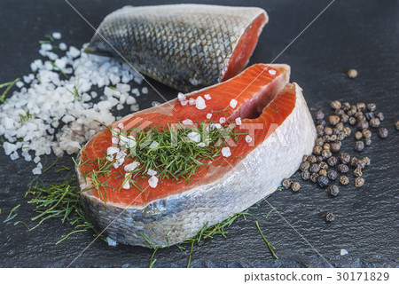 fresh salmon piece, pepper and salt on slate 30171829