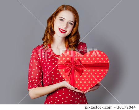 young woman with heart shaped gift 30172044