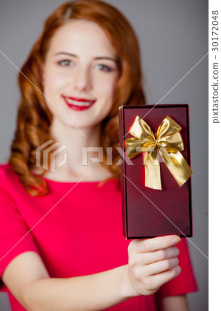 portrait of beautiful young woman with cute gift 30172048