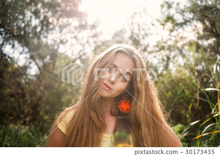 Bohemian style girl with long blond hair posing 30173435