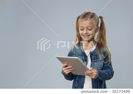 Little Teenage Girl Using Tablet Computer, Small Little Teenage Girl Using Tablet Computer, Small 30173499