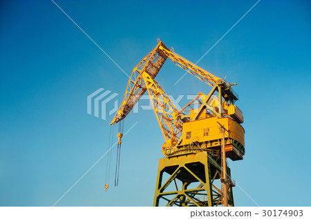 A crane at a port painted in yellow 30174903