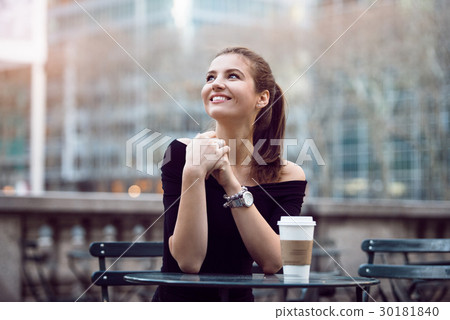 businesswoman sitting in city park during lunch 30181840