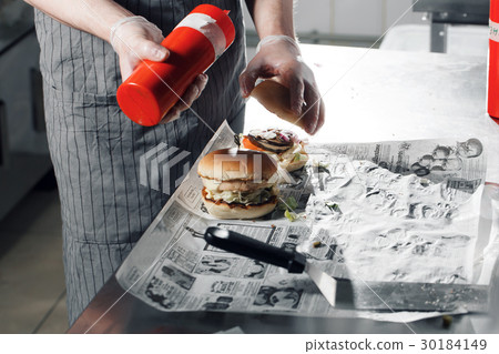 process of cooking hamburger. chef on the kitchen process of cooking hamburger. chef on the kitchen 30184149