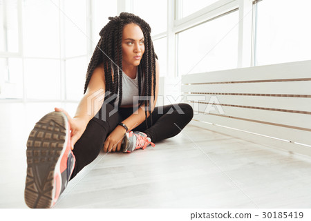 Active curvy focused lady stretching her muscles Active curvy focused lady stretching her muscles 30185419