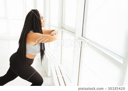 Motivated graceful lady doing squats Motivated graceful lady doing squats 30185420