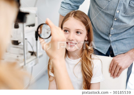 Focused clever child undergoing a checkup 30185539