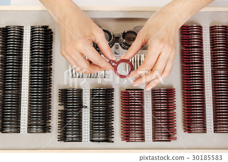 Precise experienced ophthalmologist examining the 30185583