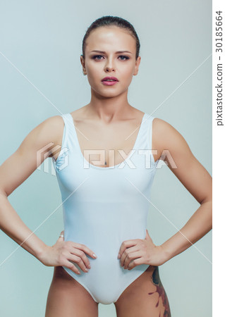 Beautiful sexy girl with tattoo in white bodysuit 30185664