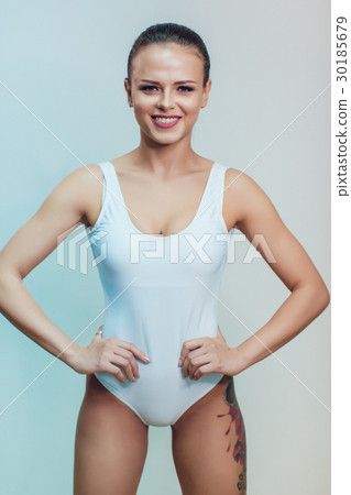 Beautiful sexy girl with tattoo in white bodysuit Beautiful sexy girl with tattoo in white bodysuit 30185679