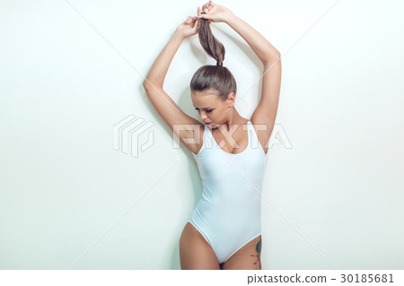 Beautiful sexy girl with tattoo in white bodysuit Beautiful sexy girl with tattoo in white bodysuit 30185681