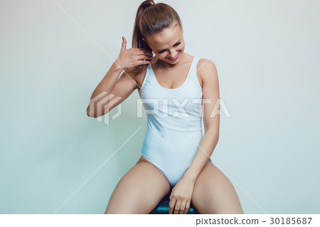 Beautiful sexy girl with tattoo in white bodysuit 30185687