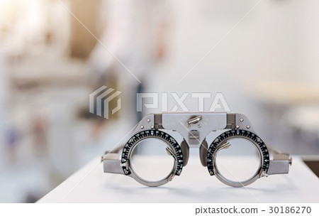 Neat ophthalmologist getting ready for appointment Neat ophthalmologist getting ready for appointment 30186270