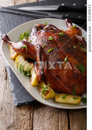 Delicious whole baked duck with apples close-up Delicious whole baked duck with apples close-up 30186631