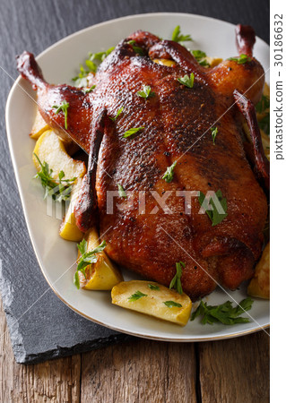 Baked duck with apples close-up on a plate 30186632