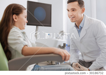 Smiling male person speaking to his young visitor 30186732