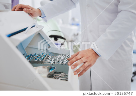 Close up of medical worker taking instrument Close up of medical worker taking instrument 30186747