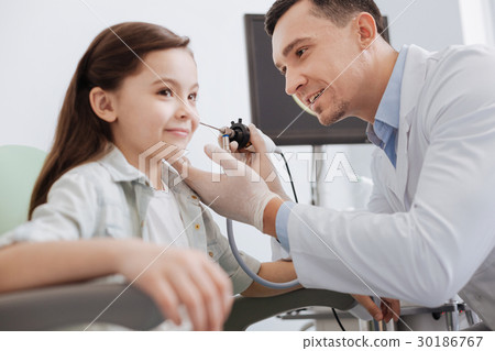 Close up of ENT doctor examining little girls ear 30186767