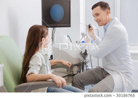 Delighted doctor looking at his little patient Delighted doctor looking at his little patient 30186768