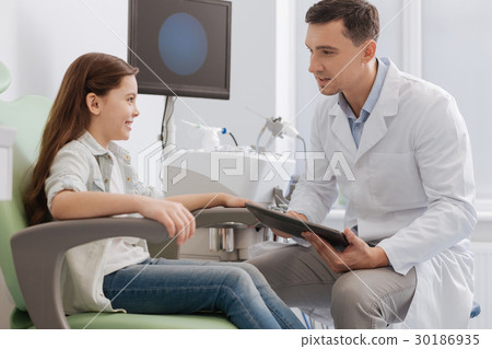 Serious young doctor using tablet Serious young doctor using tablet 30186935