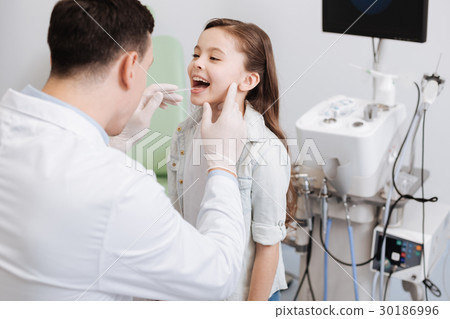 Side view of child keeping mouth wide opened Side view of child keeping mouth wide opened 30186996
