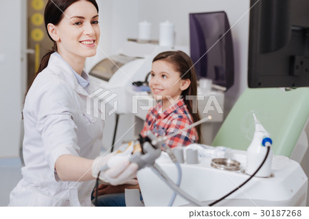 Attractive female otolaryngologist holding ent 30187268