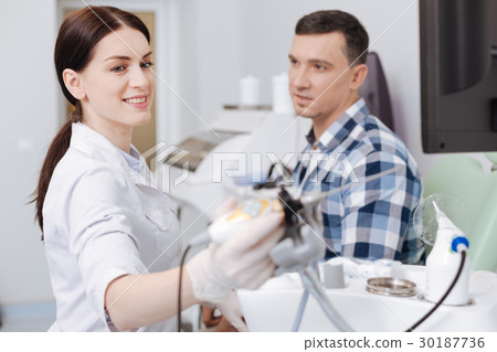 Positive delighted otolaryngologist taking 30187736