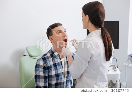 Handsome man looking at his doctor Handsome man looking at his doctor 30187743