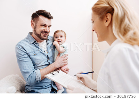 Smiling man looking at pediatrician 30187756