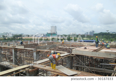 Construction workers fabricating timber form work  30187833