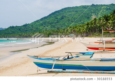 Local boats on Nacpan Beach on sunny day. El Nido Local boats on Nacpan Beach on sunny day. El Nido 30188553