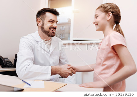 Joyful healthy little patient saying goodbye Joyful healthy little patient saying goodbye 30189130