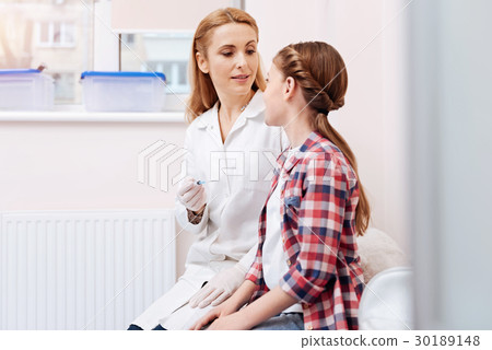 Attentive nurse looking at her patient Attentive nurse looking at her patient 30189148