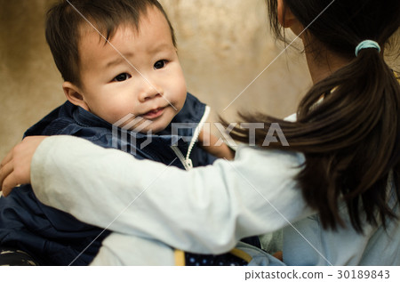 A girl hugging anxious babies A girl hugging anxious babies 30189843