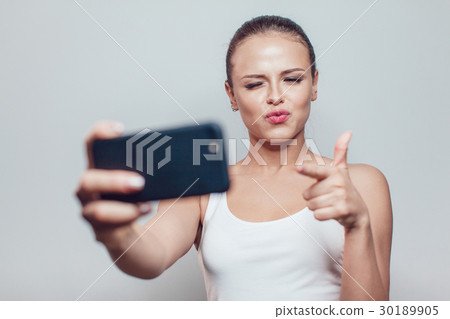 Young smiling woman having fun and make selfie on 30189905