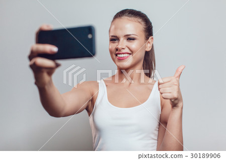 Young smiling woman having fun and make selfie on Young smiling woman having fun and make selfie on 30189906