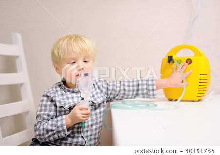 Cute boy inhalation therapy by the mask of inhaler 30191735