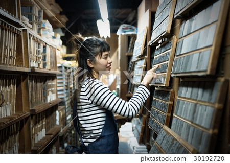 A woman in a craftwork warehouse 30192720