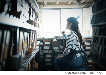 A woman in a craftwork warehouse 30192723