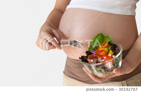 Pregnant woman's belly and vegetable salad Pregnant woman's belly and vegetable salad 30192787